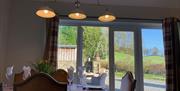 Dining space with sliding door to garden at Bishop Howe at Sawrey Cottages in Far Sawrey, Lake District