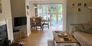 Lounge and dining space with sliding door to garden at Bishop Howe at Sawrey Cottages in Far Sawrey, Lake District