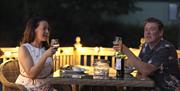 Couple enjoying a meal at Holgates Holiday Park in Silverdale, Cumbria