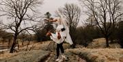 Bride and Groom Pose at The Wild Boar Inn in Windermere, Lake District