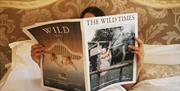 Guest Relaxing in Bed at The Wild Boar in Windermere, Lake District