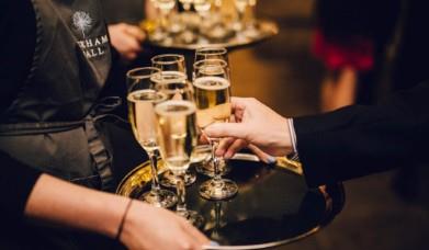 Staff serving sparkling wine at Askham Hall