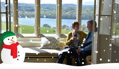 Couple sitting in a bay window at Blackwell in Bowness-on-Windermere, Lake District