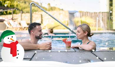 Couple in a hot tub at the Swan Hotel & Spa enjoying drinks