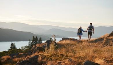 Couple holding hands and walking along a scenic Lake District path