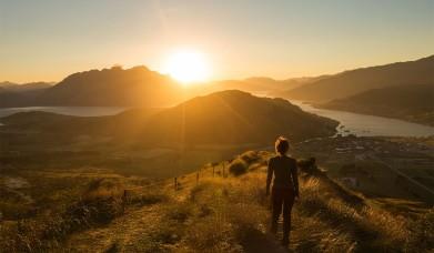 Visitor looks over a scenic Lake District sunrise