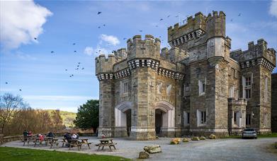 Exterior and picnic tables at Wray Castle, Low Wray, Ambleside, Lake District