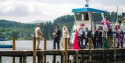 Bridal Couple and Wedding Guests Disembarking from a Windermere Lake Cruises Vessel in the Lake District, Cumbria