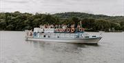 Wedding Guests on a Windermere Lake Cruises Vessel with a Scenic Backdrop in the Lake District, Cumbria