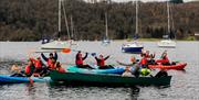 Happy Visitors Cheering from Canoes from Windermere Canoe Kayak in the Lake District, Cumbria