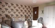 Double Bedroom with Lounge Chairs at Midtown Farm Bed and Breakfast in Easton, Cumbria