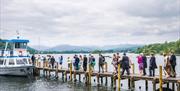 Wedding Guests on a Jetty and Windermere Lake Cruises Vessels in the Lake District, Cumbria