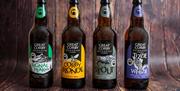 Bottles of Ales from Great Corby Brewhouse - Signal Peak, Corby Blonde, Stout, and Tizzie Whizie