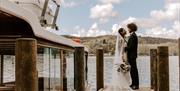 Bridal Couple on a Windermere Lake Cruises Jetty with a Scenic Backdrop in the Lake District, Cumbria