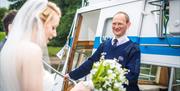 Bridal Couple Boarding a Windermere Lake Cruises Vessel in the Lake District, Cumbria