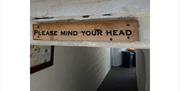'Please Mind Your Head' Sign as Seen on Ambleside Walking Tour by Cumbria Tourist Guides in the Lake District, Cumbria