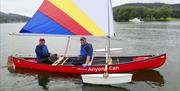 Canoe sailor with volunteer assistant