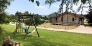 Family Swingset and Exterior of a Lodge at The Lodges at Artlegarth in Ravenstonedale, Cumbria