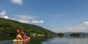 Visitors Kayaking with a Scenic View over Lake Windermere, from Windermere Canoe Kayak in the Lake District, Cumbria