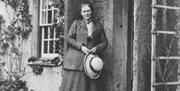 Beatrix Potter posing outside her residence at Hill Top in Near Sawrey, Ambleside, Lake District