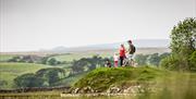 Family Looking out over Birdoswald Roman Fort near Brampton, Cumbria