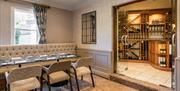 Dining Room Seating and Wine Storage at The Borrowdale Hotel in Borrowdale, Lake District