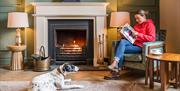 Guest and Dog Relaxing in a Cosy Lounge at The Borrowdale Hotel in Borrowdale, Lake District