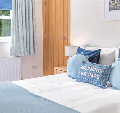 Double Bedroom with Decorative Pillow that reads "Morning Grumps" at Springbank Cottage in Coniston, Lake District