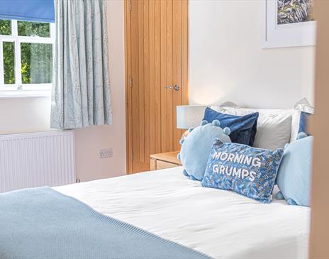 Double Bedroom with Decorative Pillow that reads "Morning Grumps" at Springbank Cottage in Coniston, Lake District
