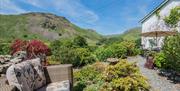 Outdoor seating and gardens at Broadrayne Farm Cottages in Grasmere, Lake District