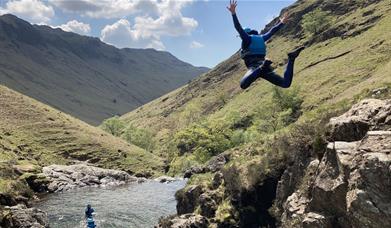 Visitors Jumping at Esk Ghyll with Crags Adventures in the Lake District, Cumbria