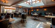 Dining Room Seating and Decor with Skylight at Crooklands Hotel in Milnthorpe, Cumbria