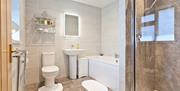 Ensuite Bathroom with a Bathtub and a Shower at The Glen Guest House in Oxenholme, Cumbria