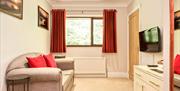 Seating Area with TV in a Double Suite at The Glen Guest House in Oxenholme, Cumbria