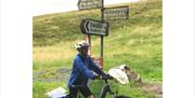 Visitor at the Crossroads of Hardknott and Wrynose Passes with E-Bike Safaris Ltd in the Lake District, Cumbria