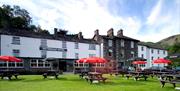 Exterior and picnic tables at The Patterdale Hotel in Ullswater, Lake District