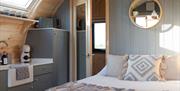 Bed and Kitchen Space inside a Pod at Eden Heights Glamping in Appleby-in-Westmorland, Cumbria