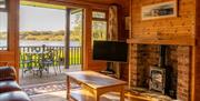 Lounge and Views from Egret Lodge at The Tranquil Otter in Thurstonfield, Cumbria