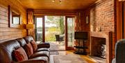 Lounge and Views from Fieldfare Lodge at The Tranquil Otter in Thurstonfield, Cumbria
