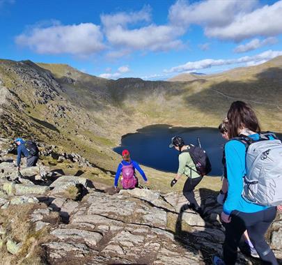 Visitors Walking Helvellyn via Striding & Swirral Edge with Guided Outdoors in the Lake District, Cumbria