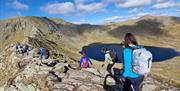 Visitors Walking Helvellyn via Striding & Swirral Edge with Guided Outdoors in the Lake District, Cumbria