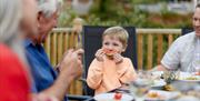 Family Enjoying a Meal at a Gatebeck Holiday Park Holiday Home in Gatebeck, Cumbria