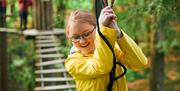 Child Smiling at Go Ape in Grizedale Forest in the Lake District, Cumbria