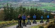 Visitors on Segways at Go Ape in Whinlatter Forest Park in Braithwaite, Lake District