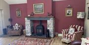Wood Burner and Seating Inside Helm Mount Lodge in Barrows Green, Cumbria