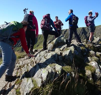 Scrambling up Striding Edge on Helvellyn with Large Outdoors in the Lake District, Cumbria