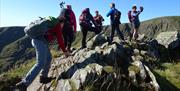 Scrambling up Striding Edge on Helvellyn with Large Outdoors in the Lake District, Cumbria