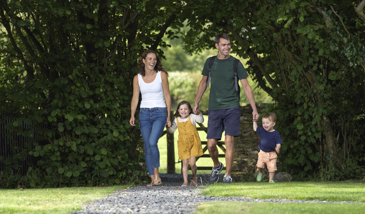 Family Walking at Hollins Farm Holiday Park in Far Arnside, Cumbria