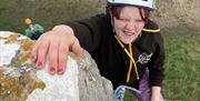 young adult girl outdoor rock climbing