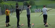 Visitors Practicing Archery with Joint Adventures in the Lake District, Cumbria